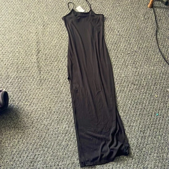 Rue 21, size MEDIUM, NEVER WORN, Long black dress with a slit down one leg.